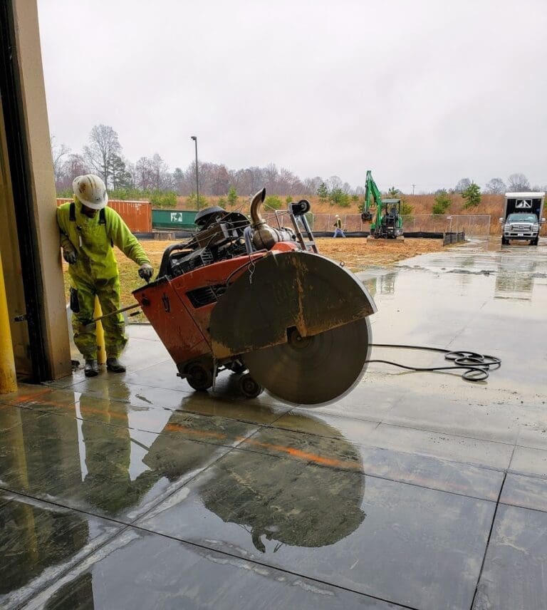 Man with concrte saw cutting the concrete slab