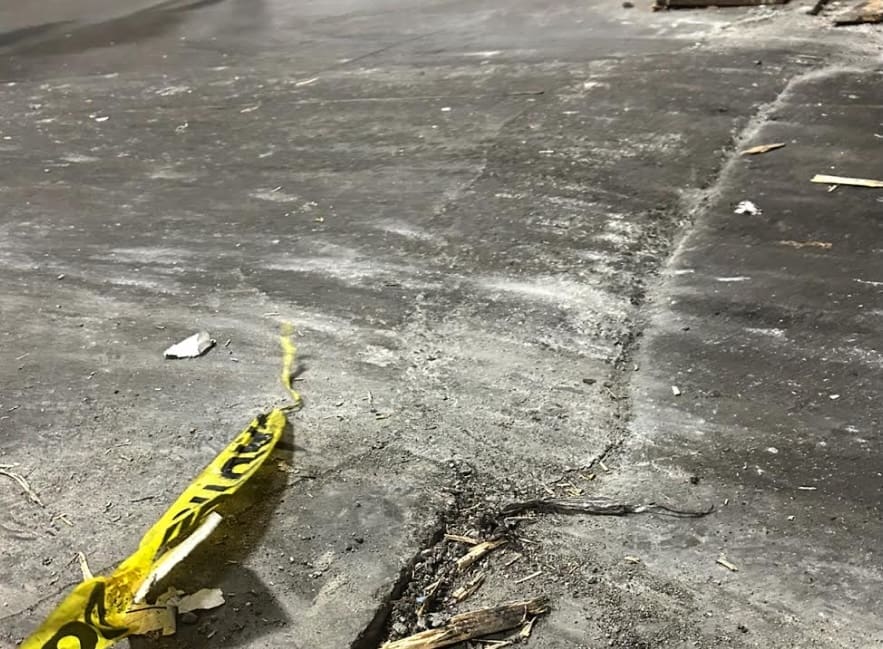 A heaving concrete joint that was hastily repaired or patched