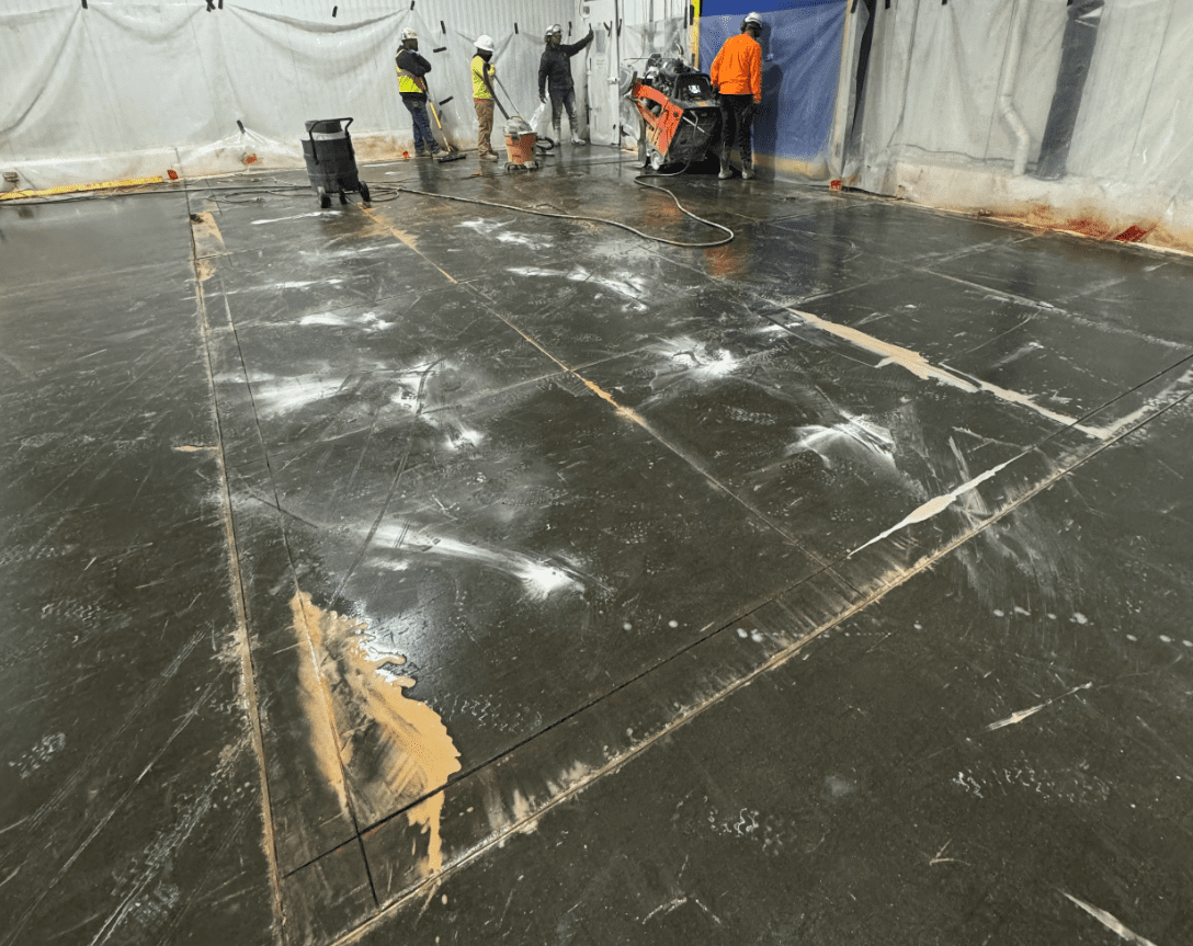 Men cutting concrete pad