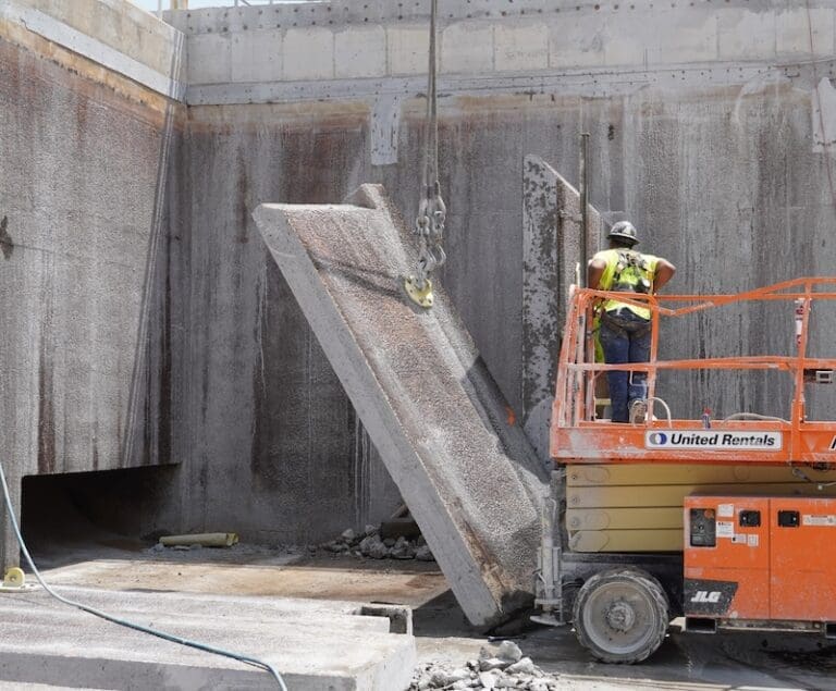 Guy in lift removing concrete slab