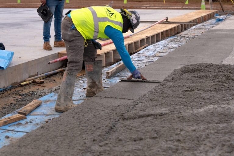 Man troweling concrete when its cold